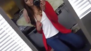 girl tapes herself in the mirror, while masturbating with a dildo.